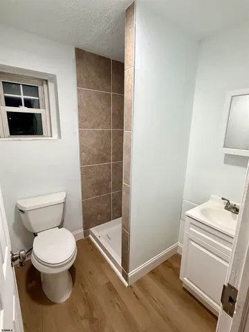 a white toilet sitting next to a bathroom sink