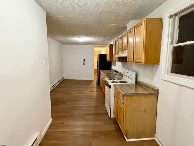 a kitchen with stainless steel appliances granite countertop a stove and a sink