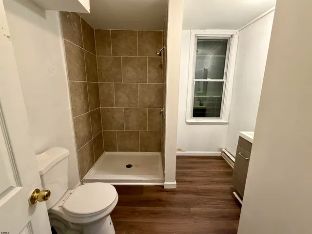 a bathroom with a toilet and a shower