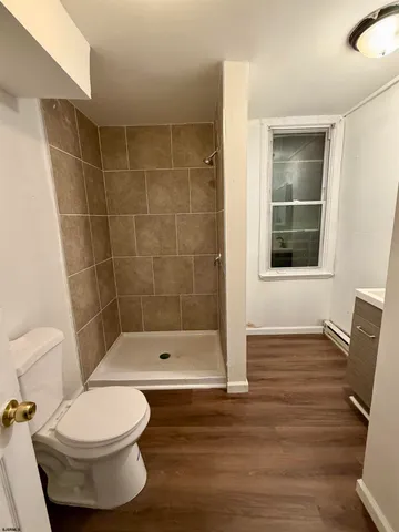 a bathroom with a toilet and a shower