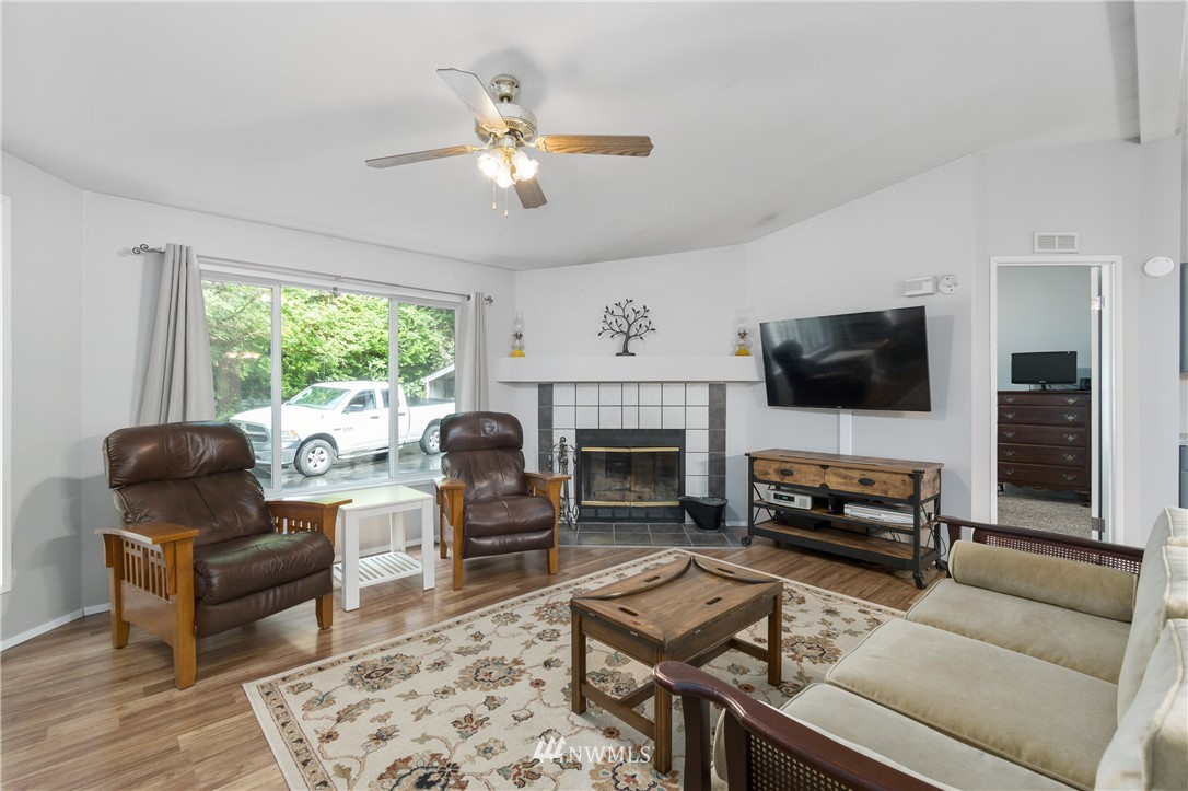 106 Slide Creek Road Longview, WA 98632 - Photo 15 of 38 a living room with furniture fireplace and a large window