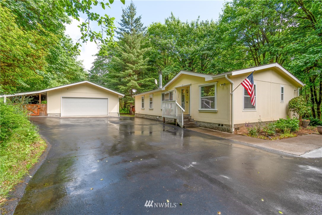 106 Slide Creek Road Longview, WA 98632 - Photo 3 of 38 a view of a house with a yard and large trees
