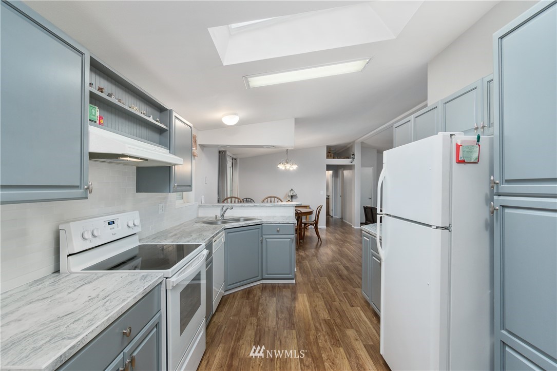 106 Slide Creek Road Longview, WA 98632 - Photo 24 of 38 a kitchen with a refrigerator a sink and a stove top oven