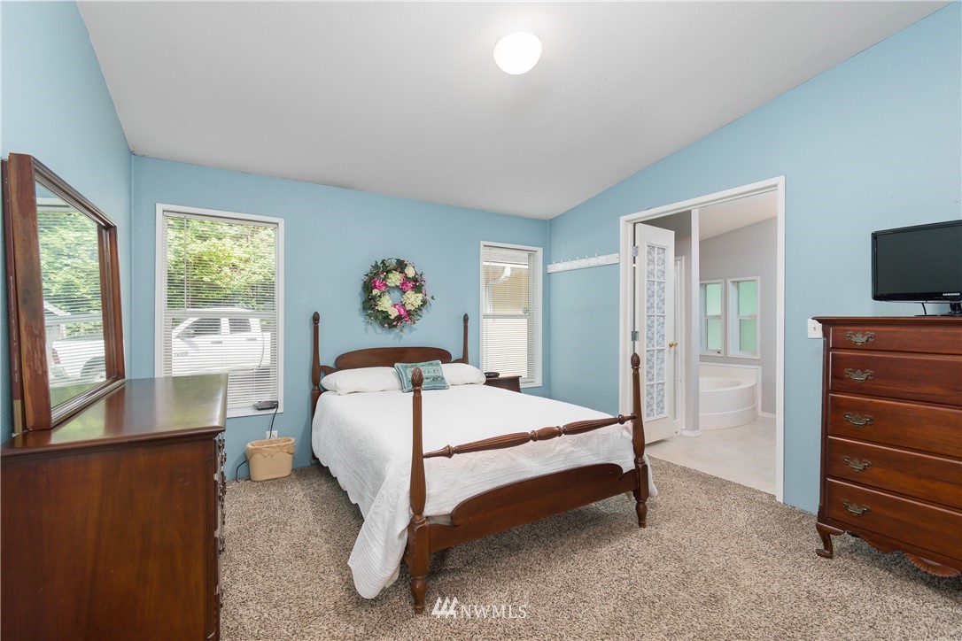106 Slide Creek Road Longview, WA 98632 - Photo 30 of 38 a bed sitting in a bedroom next to a window