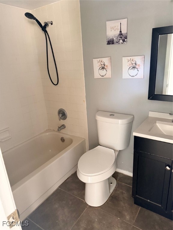 721 Gilbert Avenue South Lehigh Acres, FL 33973 - Photo 6 of 13 a white toilet sitting next to a bathroom sink and a shower