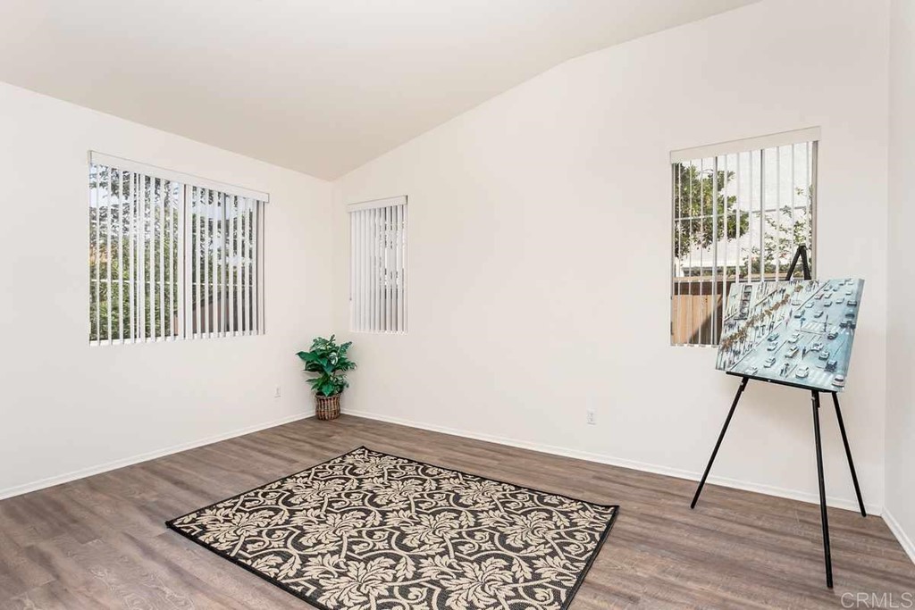 567 Big Sky Drive Oceanside, CA 92058 - Photo 13 of 27 a view of an empty room with wooden floor and a rug