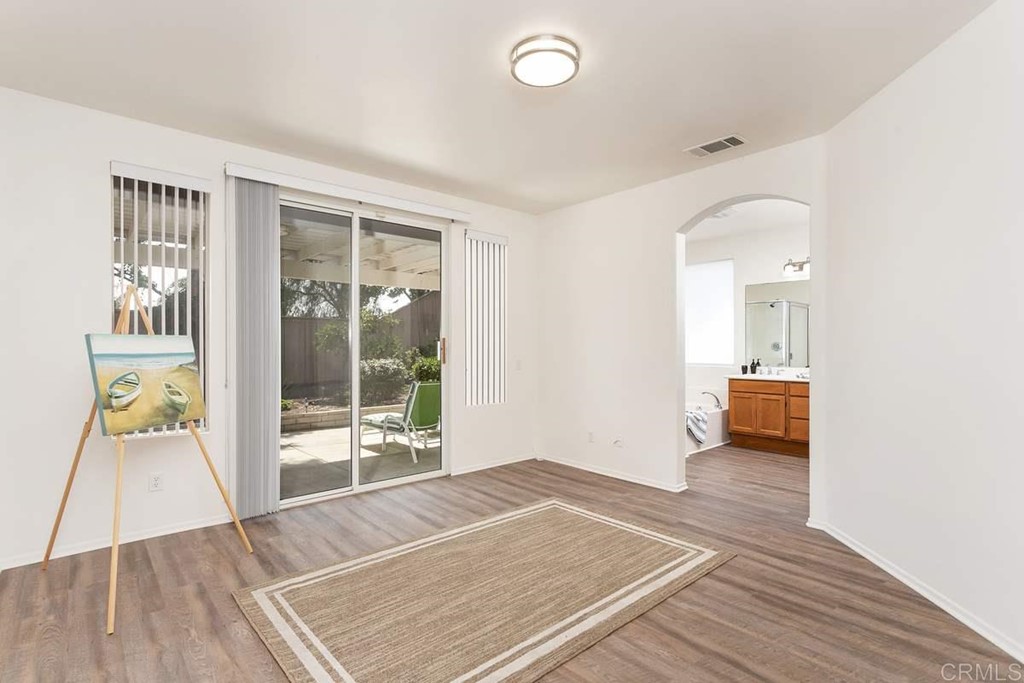 567 Big Sky Drive Oceanside, CA 92058 - Photo 14 of 27 an empty room with wooden floor and windows