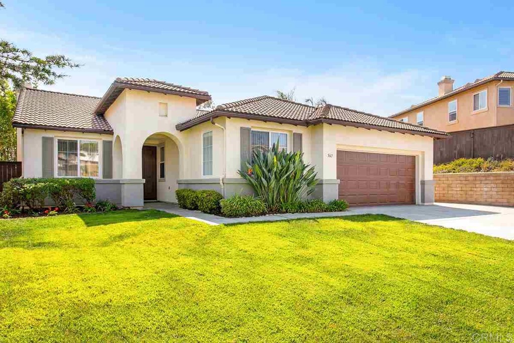 567 Big Sky Drive Oceanside, CA 92058 - Photo 2 of 27 a front view of a house with a yard