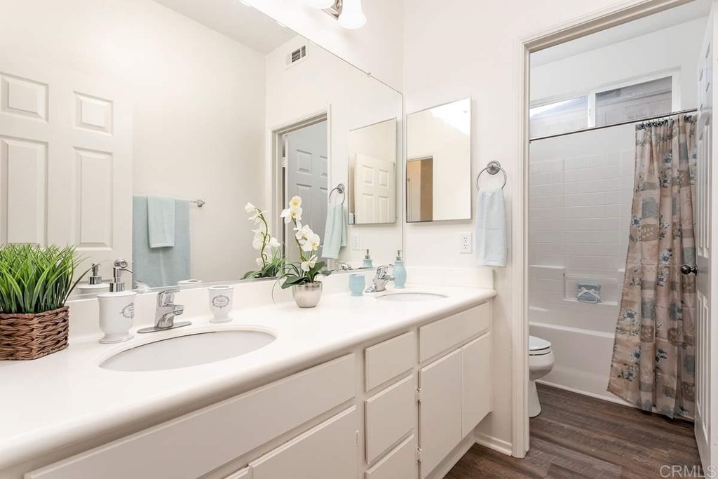 567 Big Sky Drive Oceanside, CA 92058 - Photo 20 of 27 a bathroom with a double vanity sink toilet and shower