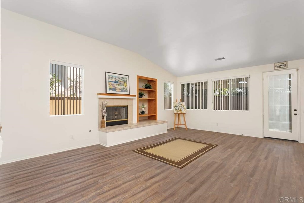 567 Big Sky Drive Oceanside, CA 92058 - Photo 6 of 27 a view of an empty room with wooden floor and a window