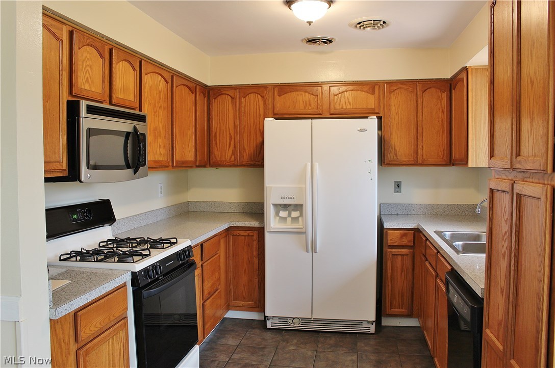 10702 Chillicothe Road Kirtland, OH 44094 - Photo 2 of 25 Lots of cabinet space in this Kitchen with newer ceramic tile floor.