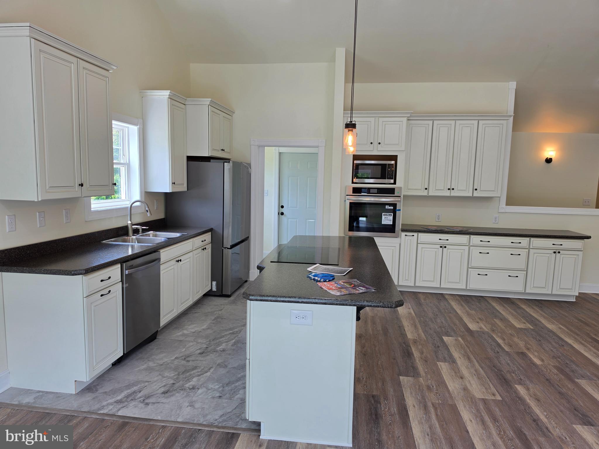13514 Old Cresaptown Road Southwest Lavale, MD 21502 - Photo 9 of 25 a kitchen with kitchen island white cabinets and stainless steel appliances