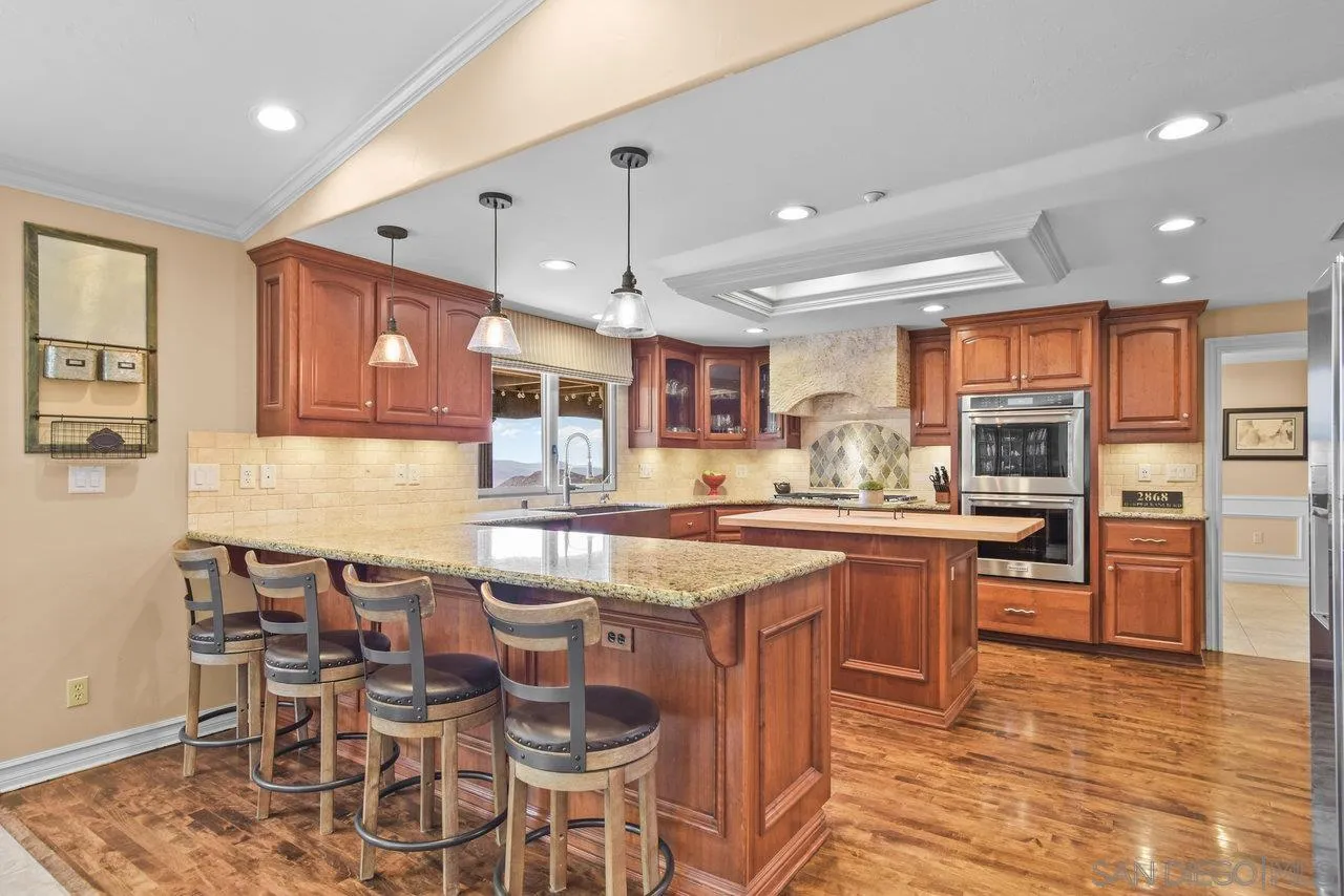 2868 Harper Ranch Road Jamul, CA 91935 - Photo 14 of 59 a kitchen with lots of counter space and windows