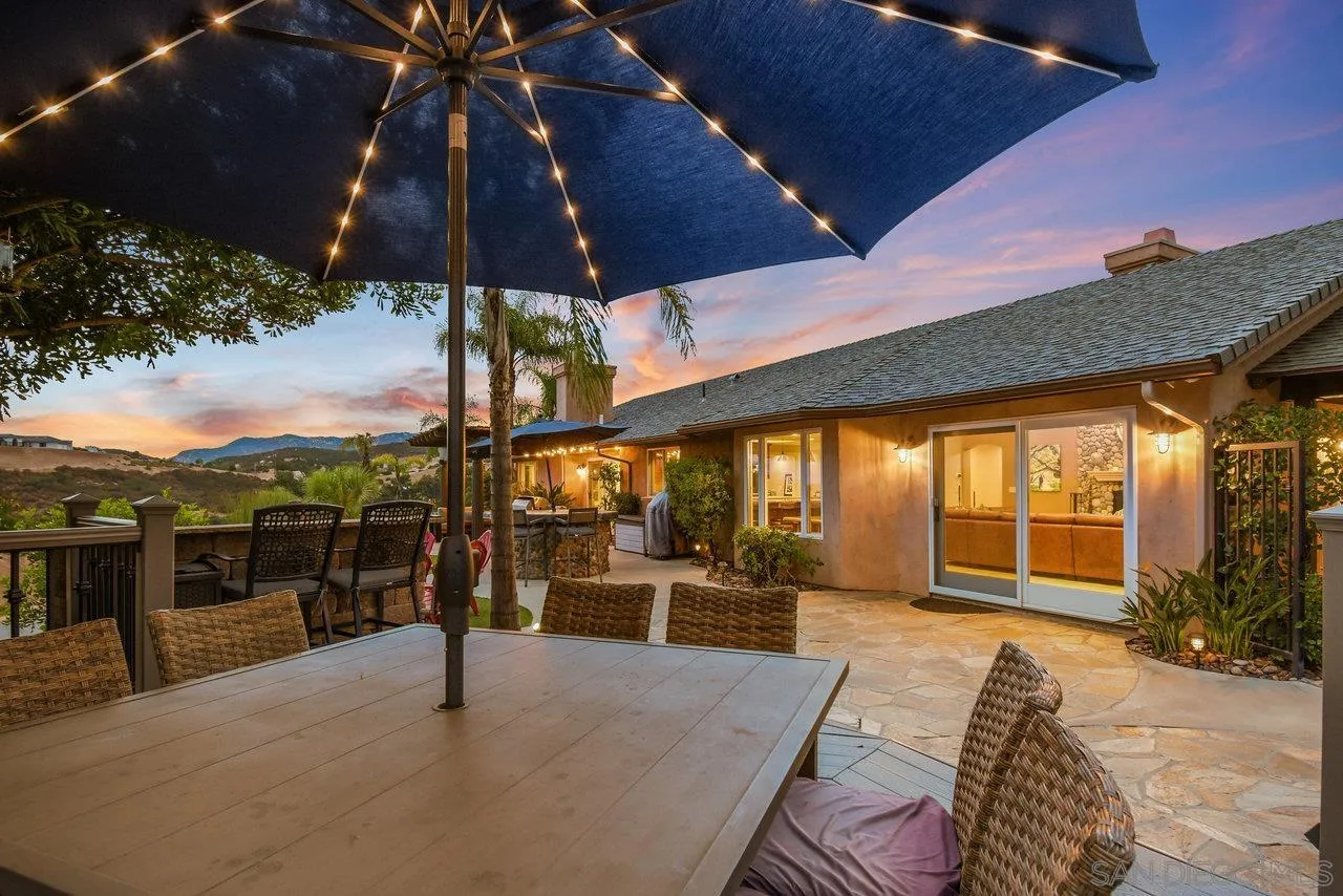 2868 Harper Ranch Road Jamul, CA 91935 - Photo 57 of 59 a view of a patio with a table and chairs under an umbrella