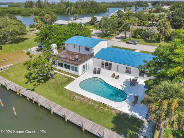 an aerial view of a house with a lake view