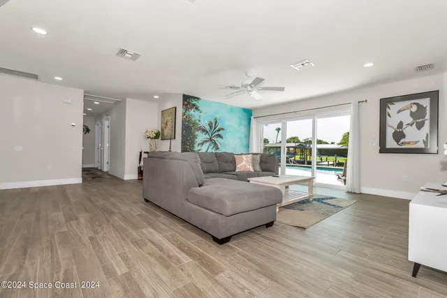 a kitchen with granite countertop white cabinets white appliances and sink