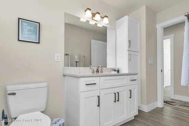 a bedroom with a bed and a lamp with wooden floor