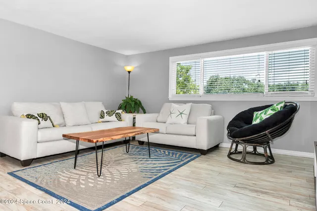 a bedroom with a bed and painting on the wall