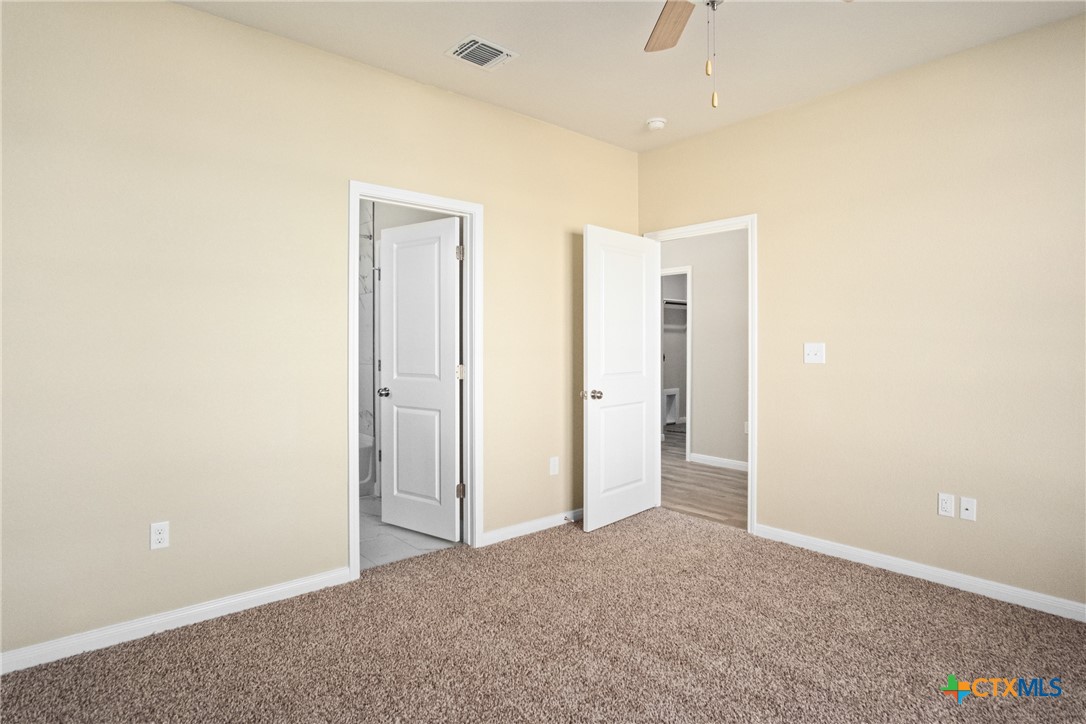 3211 Llano Alto Circle Temple, TX 76504 - Photo 14 of 29 an empty room with closet and a chandelier fan