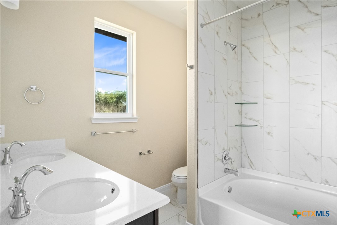 3211 Llano Alto Circle Temple, TX 76504 - Photo 15 of 29 a bathroom with a sink a bathtub and a window