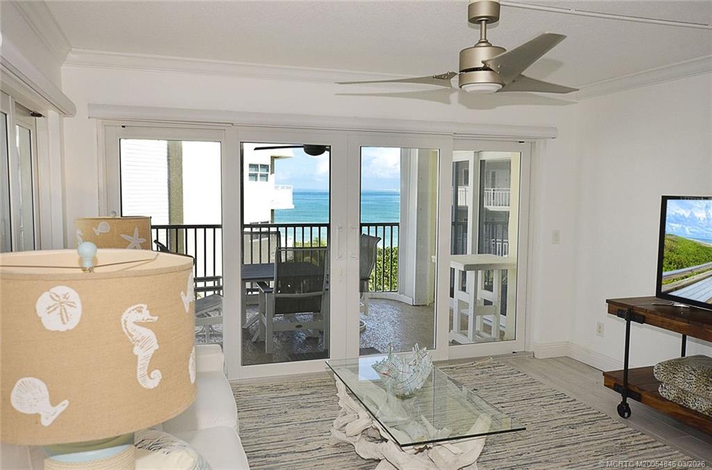 529 Northeast Plantation Road, Unit 310 Jensen Beach, FL 34957 - Photo 10 of 12 a view of a bedroom with wooden floor and a window