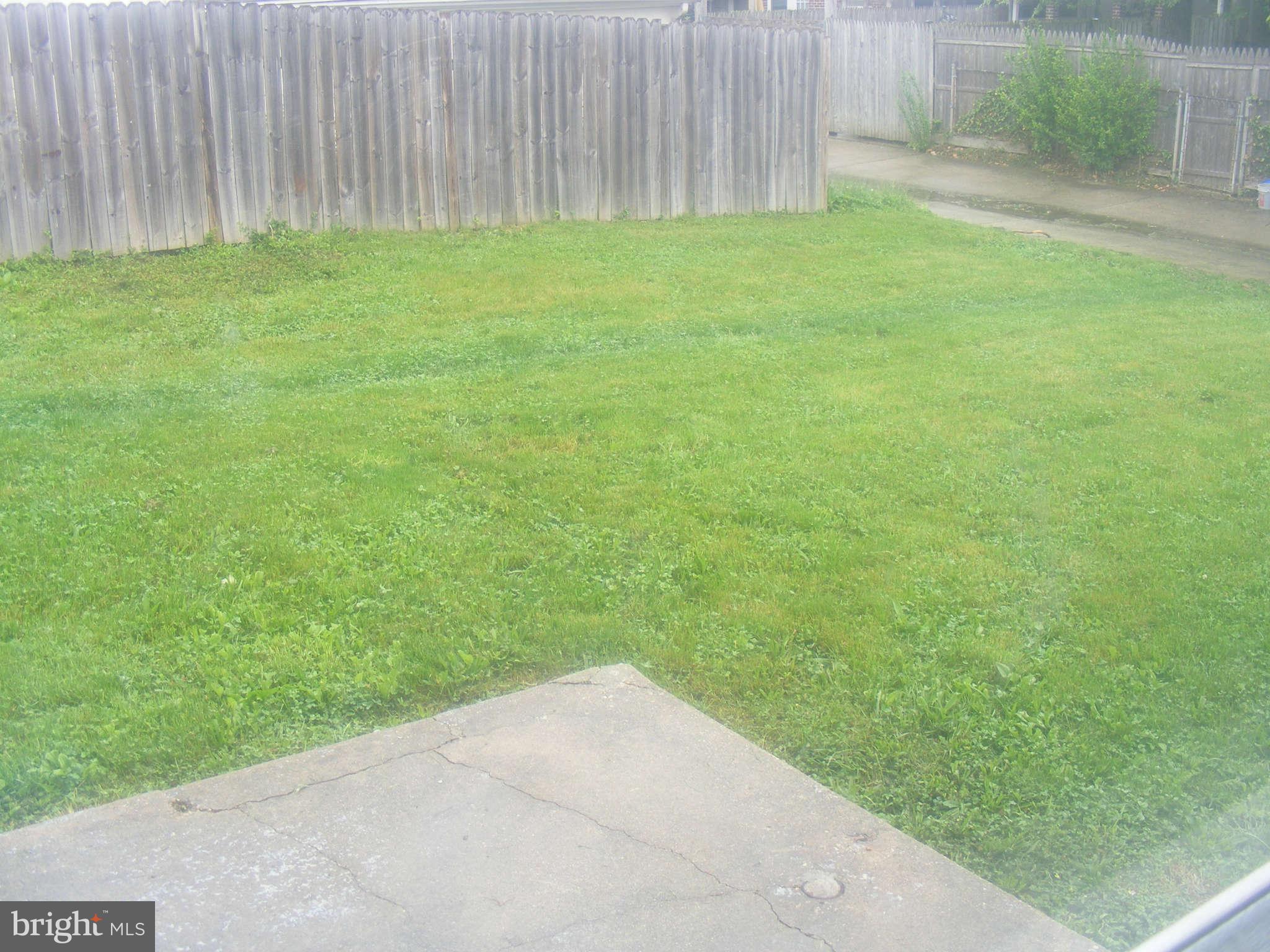 8503 Chestnut Oak Road Baltimore, MD 21234 - Photo 4 of 13 a view of a yard with a wooden fence