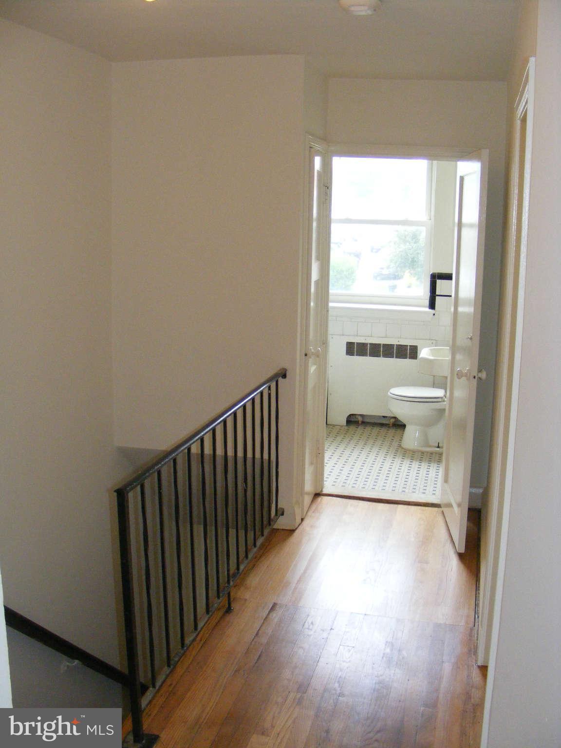 8503 Chestnut Oak Road Baltimore, MD 21234 - Photo 8 of 13 a view of a room with a wooden floor and a floor to ceiling window