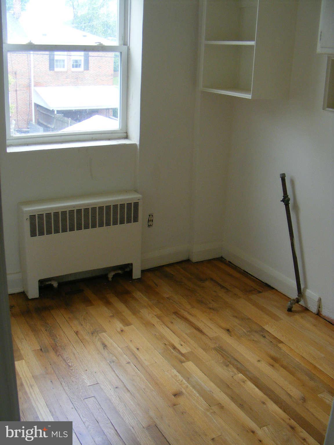 8503 Chestnut Oak Road Baltimore, MD 21234 - Photo 9 of 13 a view of a room with wooden floor and a window