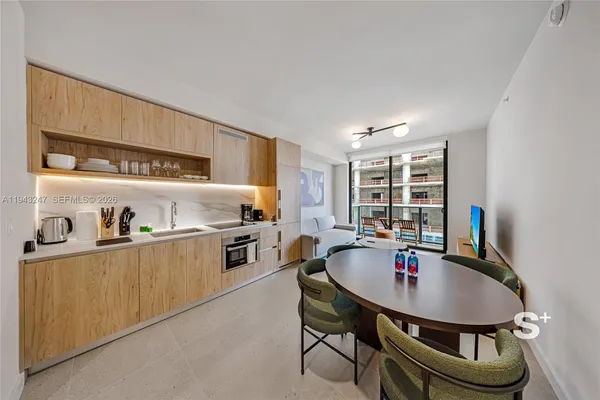 a kitchen with a table chairs stove and cabinets