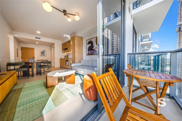 a living room with furniture a rug and a chandelier