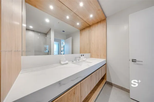a bathroom with a double vanity sink and mirror