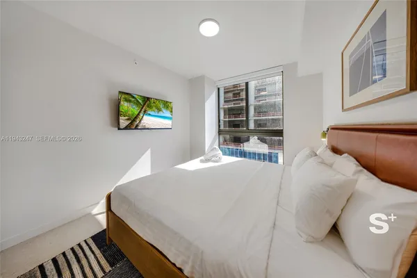 a bedroom with a bed and a window
