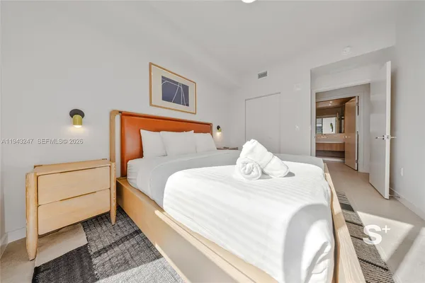 a large white bed in a white room