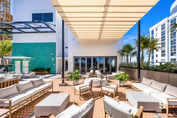 a view of a patio with chairs and tables