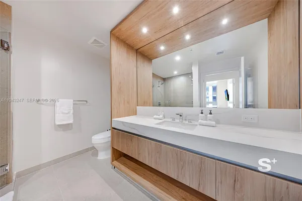 a bathroom with a double vanity sink and a mirror