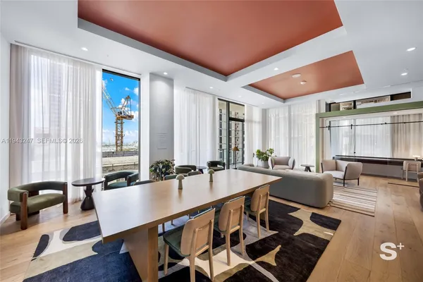 a living room with furniture and large windows