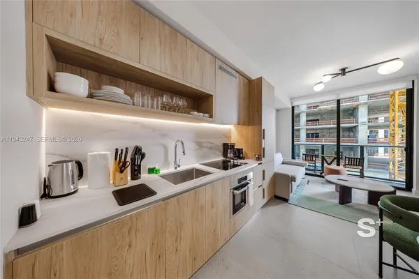 a kitchen with stainless steel appliances granite countertop a sink and stove top oven