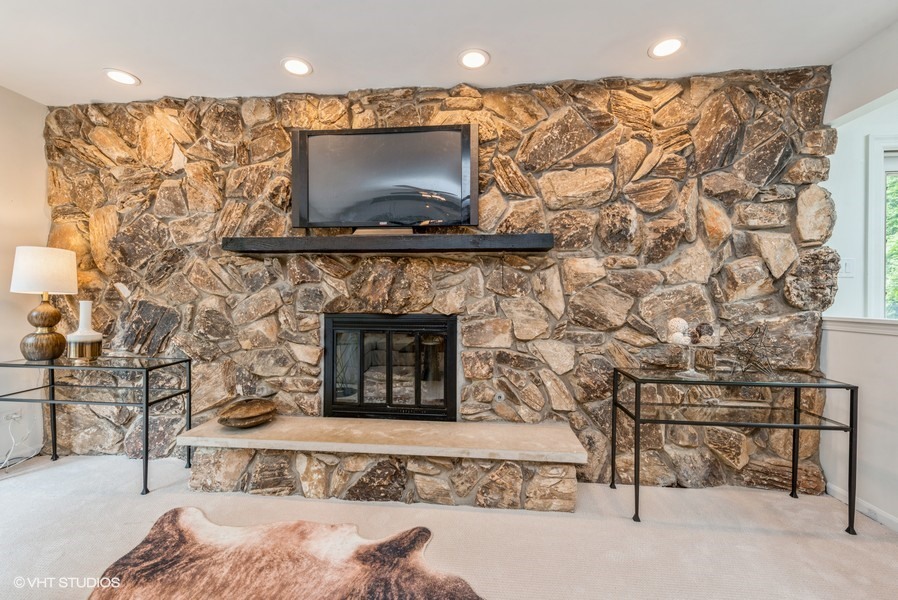 223 Brookbridge Road Trout Valley, IL 60013 - Photo 8 of 33 a living room with a fireplace and a flat screen tv