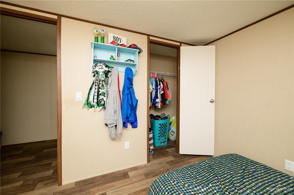 818 South 13th Street Alamo, TX 78516 - Photo 12 of 24 a view of walk in closet with clothes and shoes