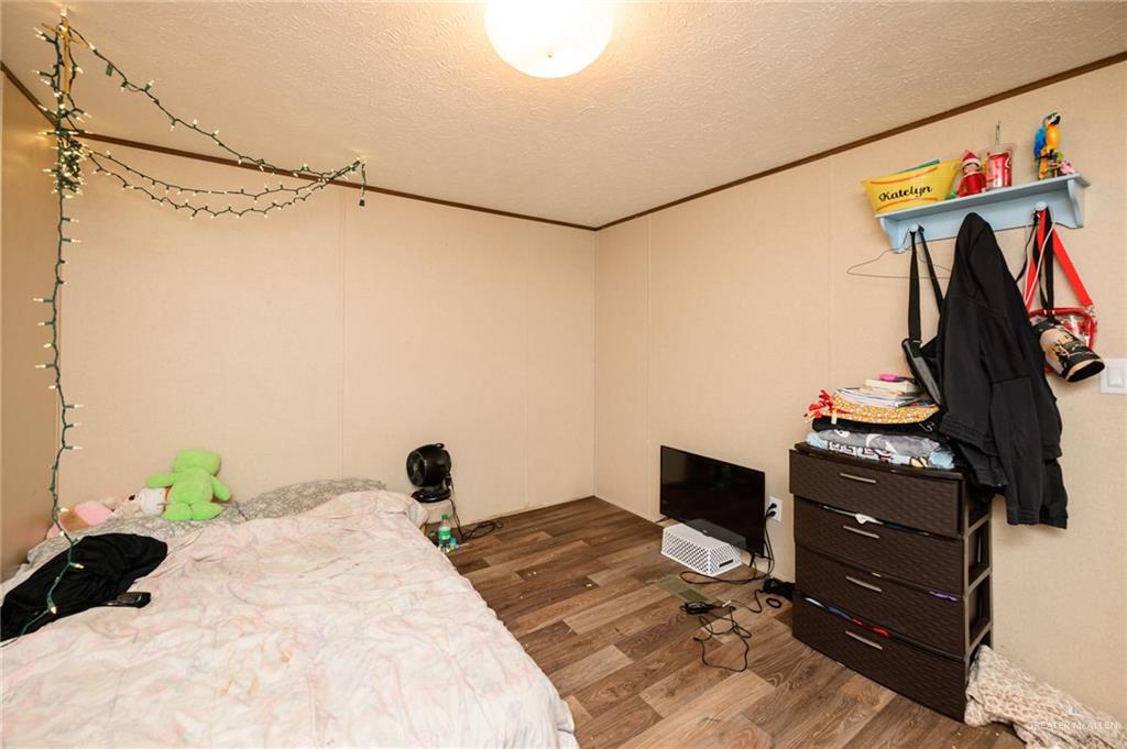 818 South 13th Street Alamo, TX 78516 - Photo 14 of 24 a bedroom with a bed and a closet
