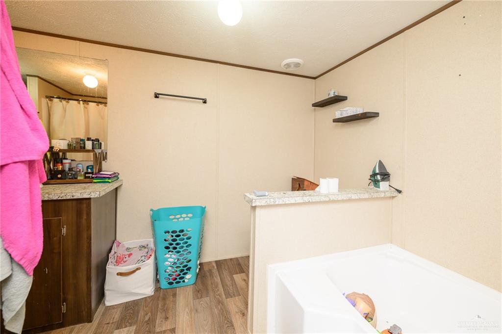 818 South 13th Street Alamo, TX 78516 - Photo 17 of 24 a bathroom with a sink mirror and vanity