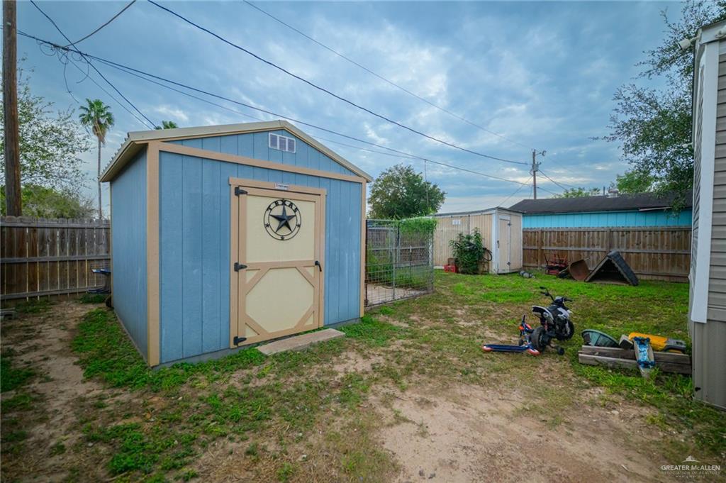 818 South 13th Street Alamo, TX 78516 - Photo 23 of 24 a backyard of a house with wooden chairs and a table and chairs
