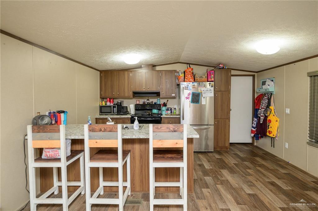 818 South 13th Street Alamo, TX 78516 - Photo 3 of 24 a view of a kitchen with refrigerator and workspace