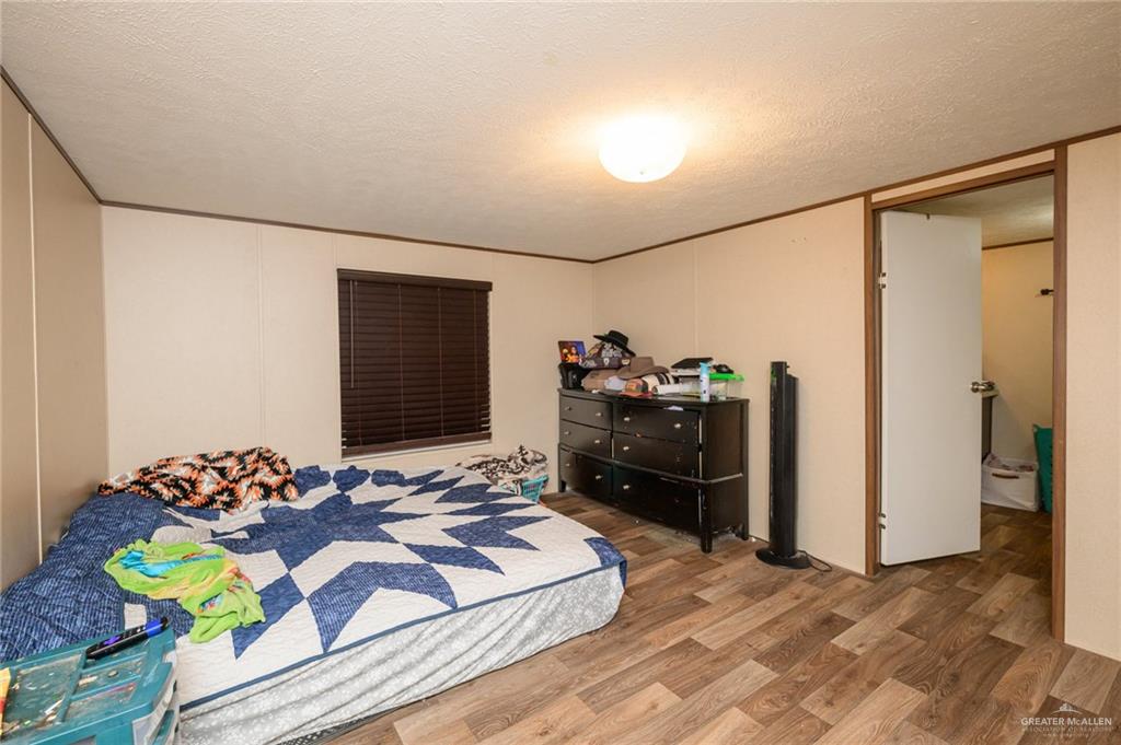 818 South 13th Street Alamo, TX 78516 - Photo 9 of 24 a bed room with a bed and a television
