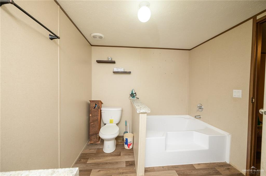 818 South 13th Street Alamo, TX 78516 - Photo 10 of 24 a bathroom with a bathtub and a shower