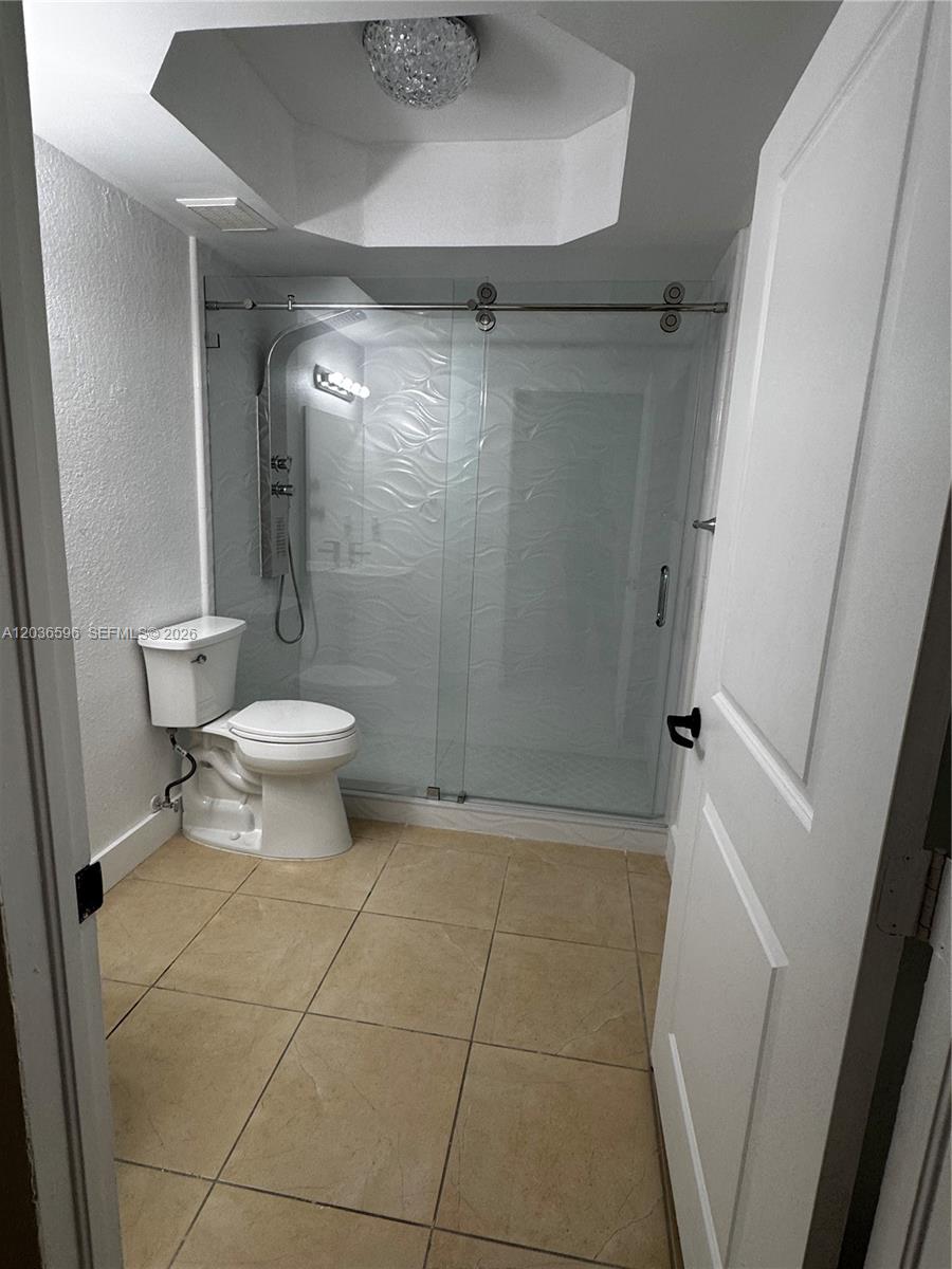 2301 Southwest 27th Avenue, Unit 503 Miami, FL 33145 - Photo 17 of 24 a bathroom with a toilet and a shower