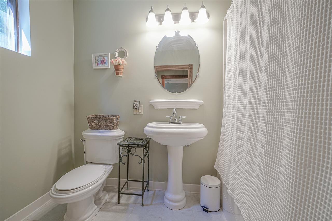 1052 South Harmony Road Oregon, IL 61061 - Photo 17 of 25 a bathroom with a toilet sink and mirror