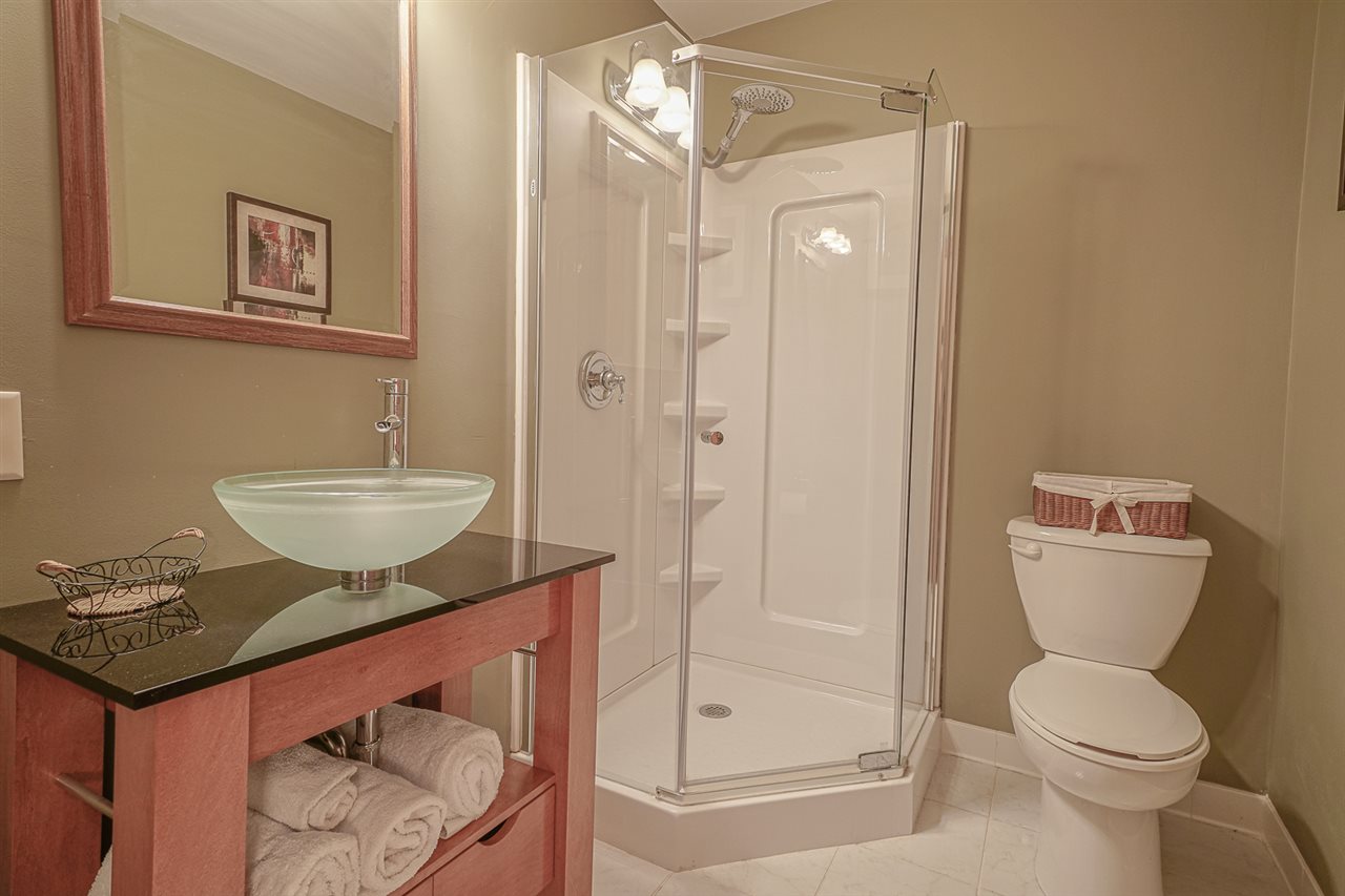 1052 South Harmony Road Oregon, IL 61061 - Photo 21 of 25 a bathroom with a granite countertop sink a toilet and shower