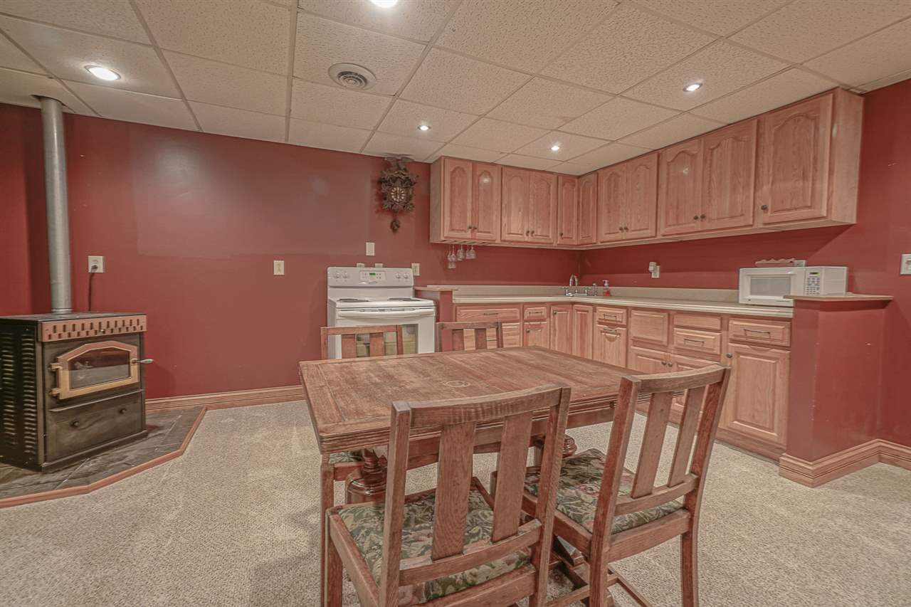 1052 South Harmony Road Oregon, IL 61061 - Photo 22 of 25 a kitchen with stainless steel appliances granite countertop a table chairs sink and cabinets