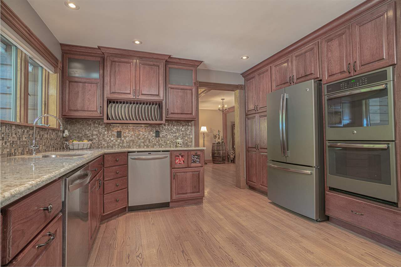 1052 South Harmony Road Oregon, IL 61061 - Photo 3 of 25 a kitchen with stainless steel appliances granite countertop a refrigerator stove and sink